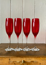 Load image into Gallery viewer, A set of 4 vintage cranberry glass champagne flutes
