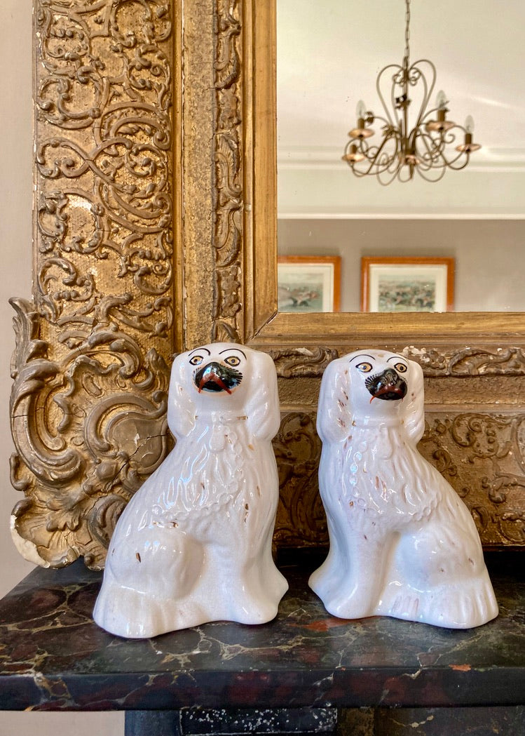 A pair of white Staffordshire mantle dogs