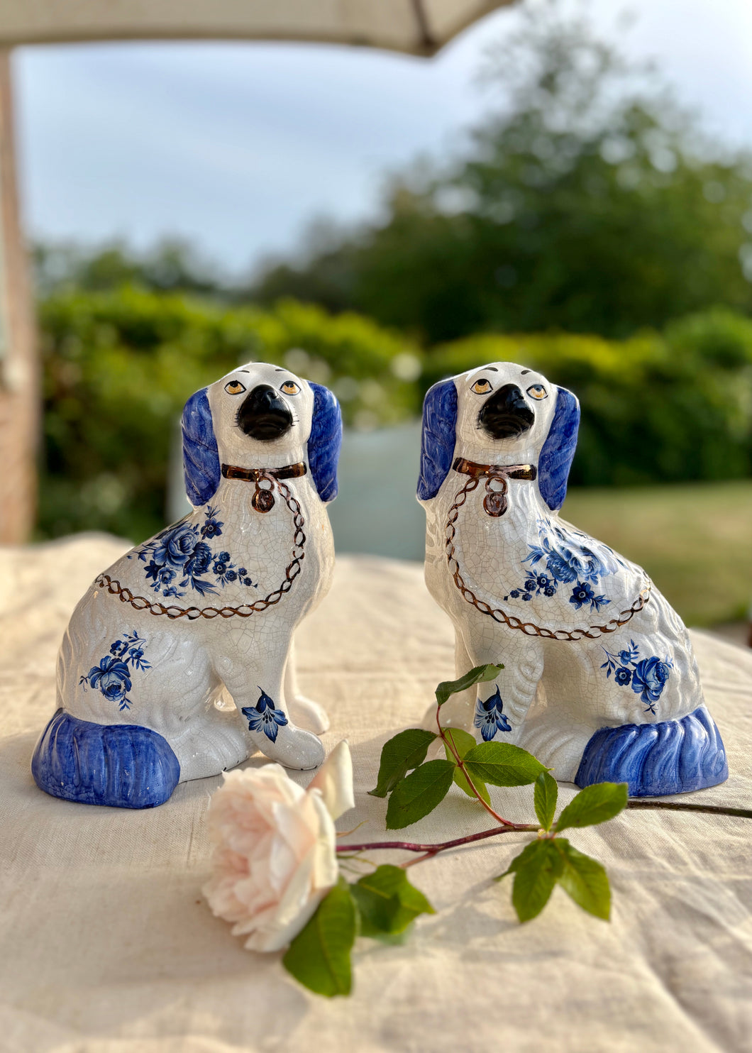 A pair of blue and white floral Staffordshire Dogs