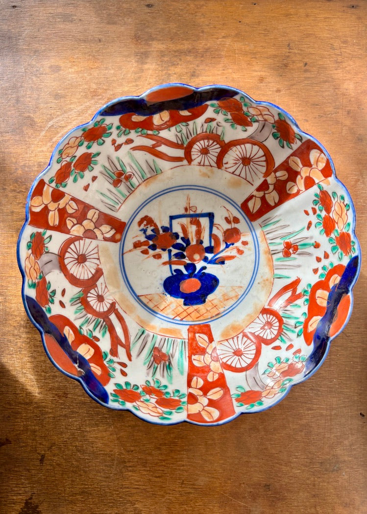 Vibrant hand decorated oriental bowl with scalloped rim