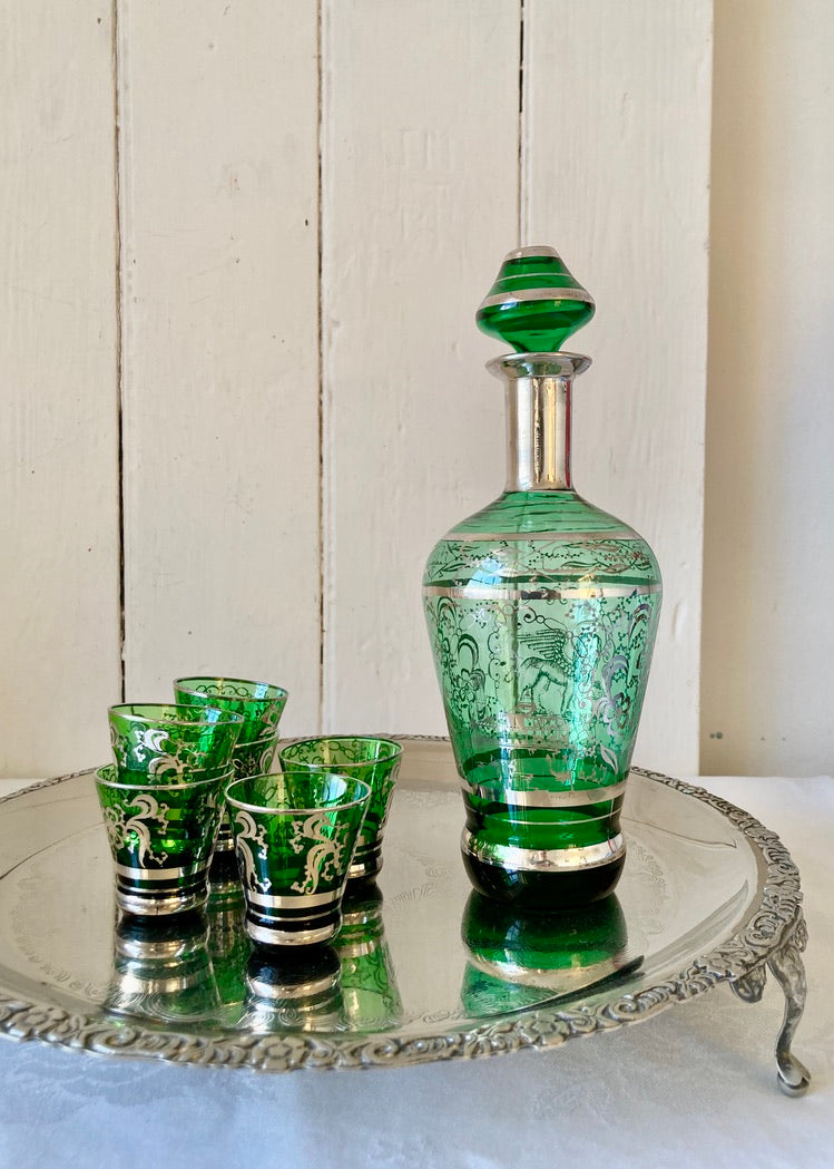 A green glass, silver embossed Venetian decanter and six shot glasses