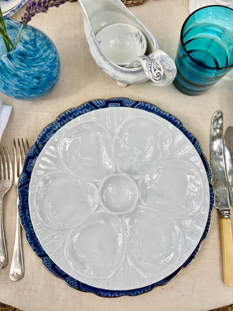 A set of 4 French white porcelain oyster plates