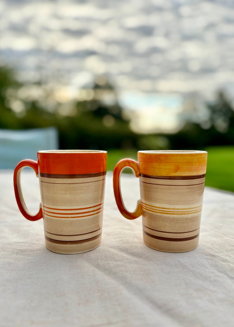 A stylish pair of mid-century hand painted mugs