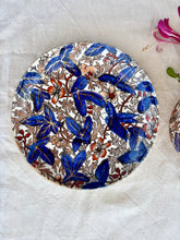 Load image into Gallery viewer, A large cup and saucer with botanical decoration
