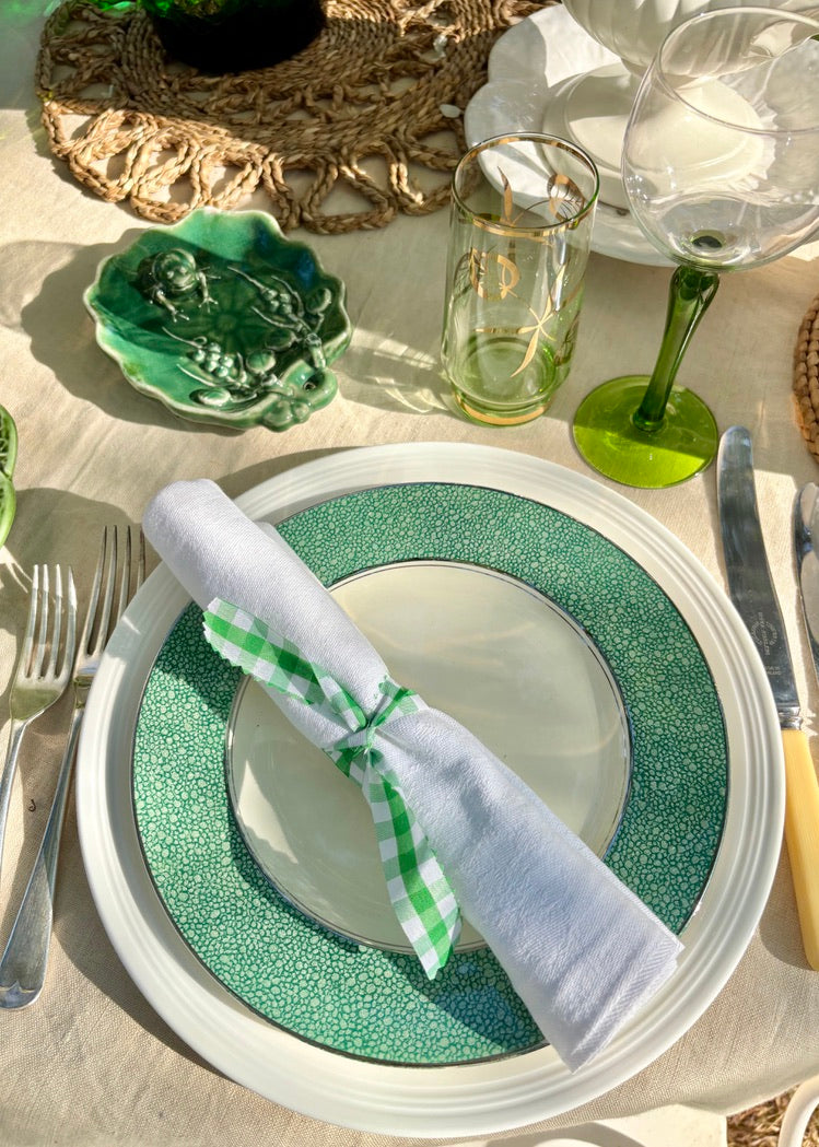 A set of 4 green bordered plates with silver gilt trim