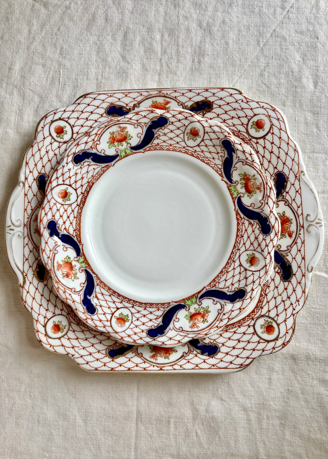 A square cake serving plate and set of 7 matching small plates