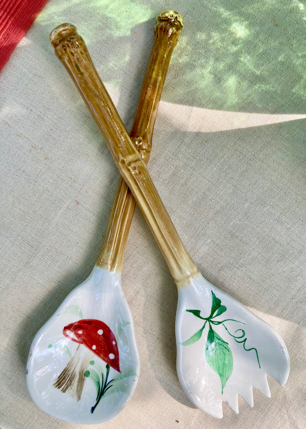 A pair of Italian ceramic salad servers with faux bamboo handles