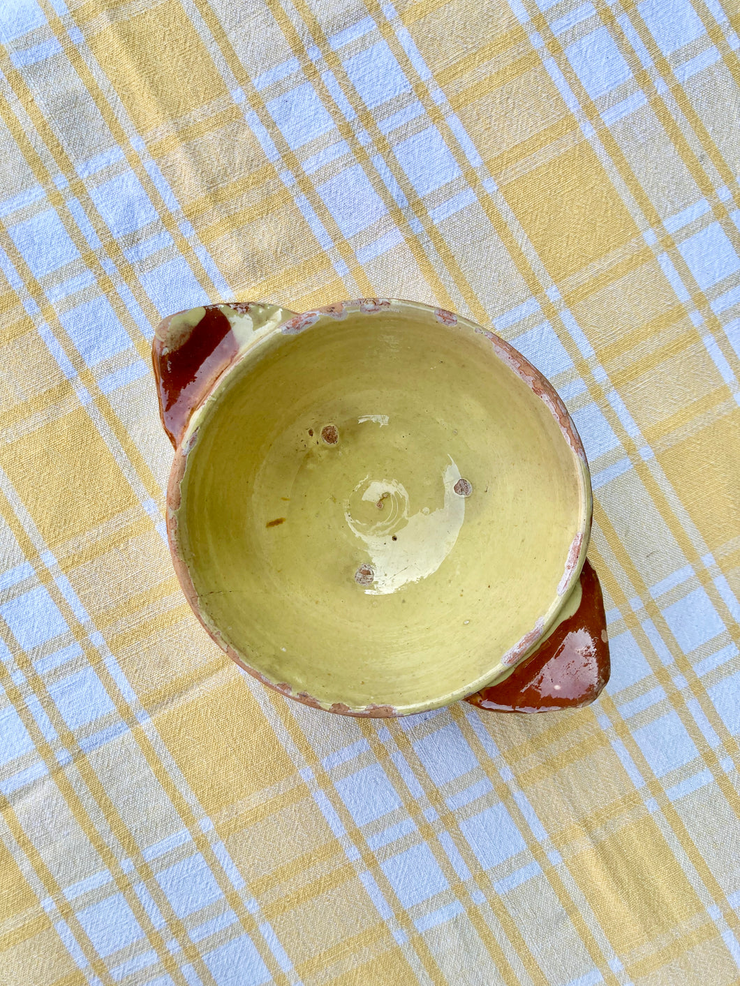 Yellow glazed cafe au lait lug bowl in terracotta