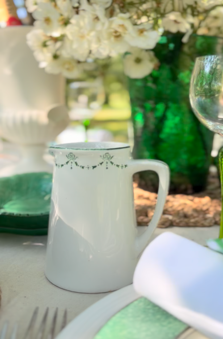 Small white cream jug with green trim by Maddock & Sons Ltd