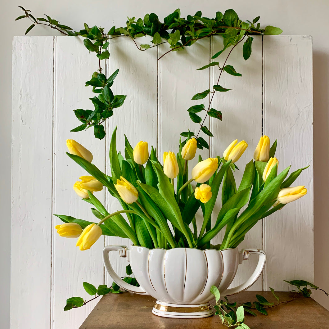 Creamy white scalloped mantle vase with gilt trim and original wire frog