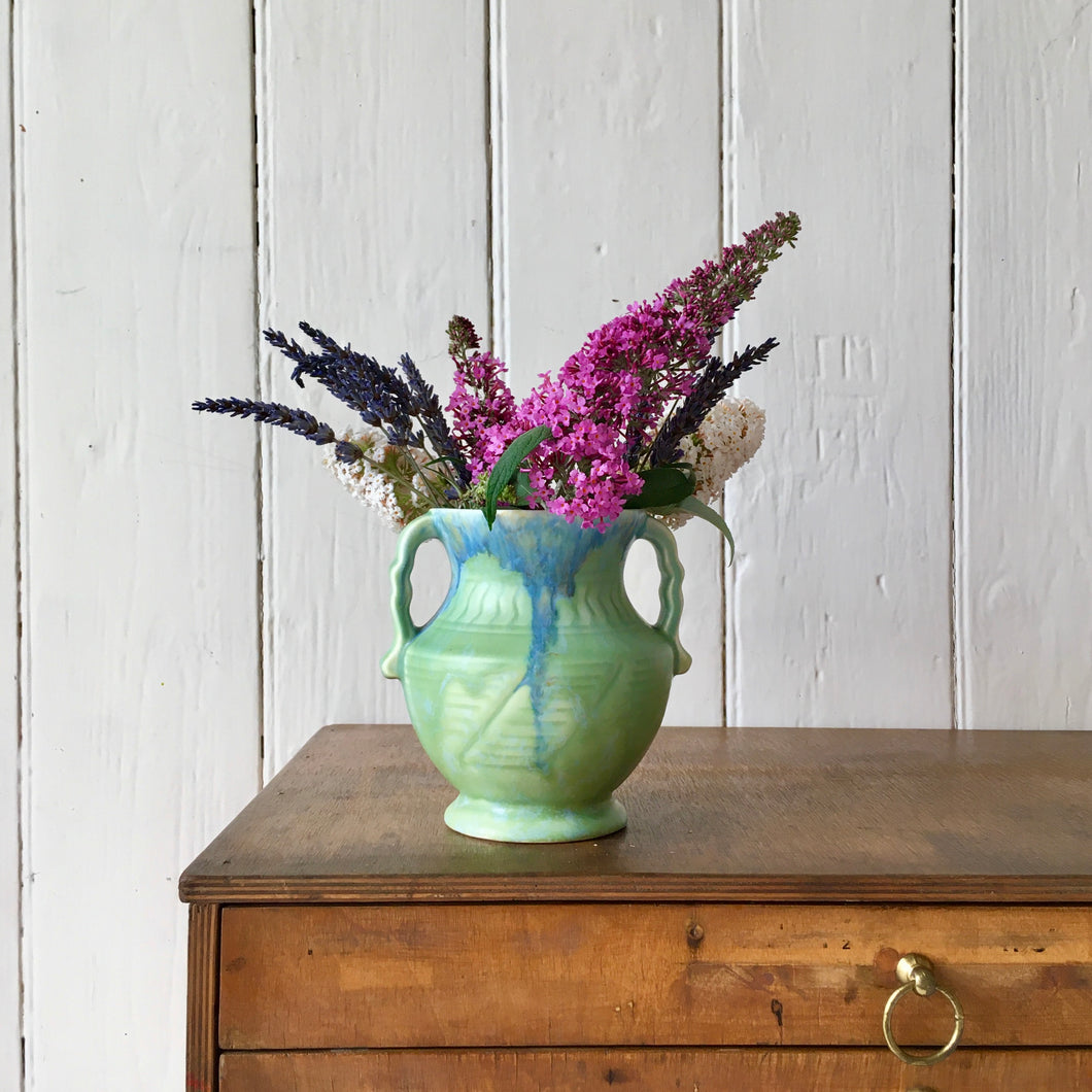 Pale green two handled vase with blue marbling effect